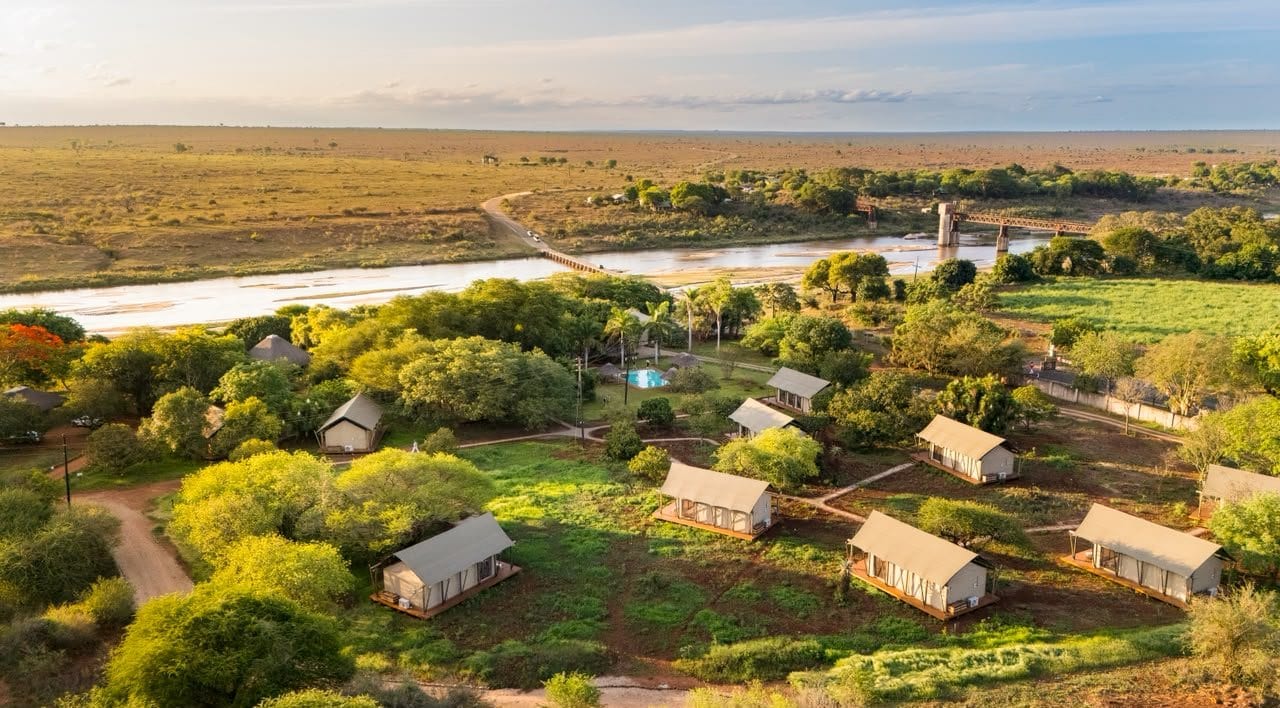 Elephant Walk from the air: safari tents among trees, the Crocodile River and the Kruger beyond