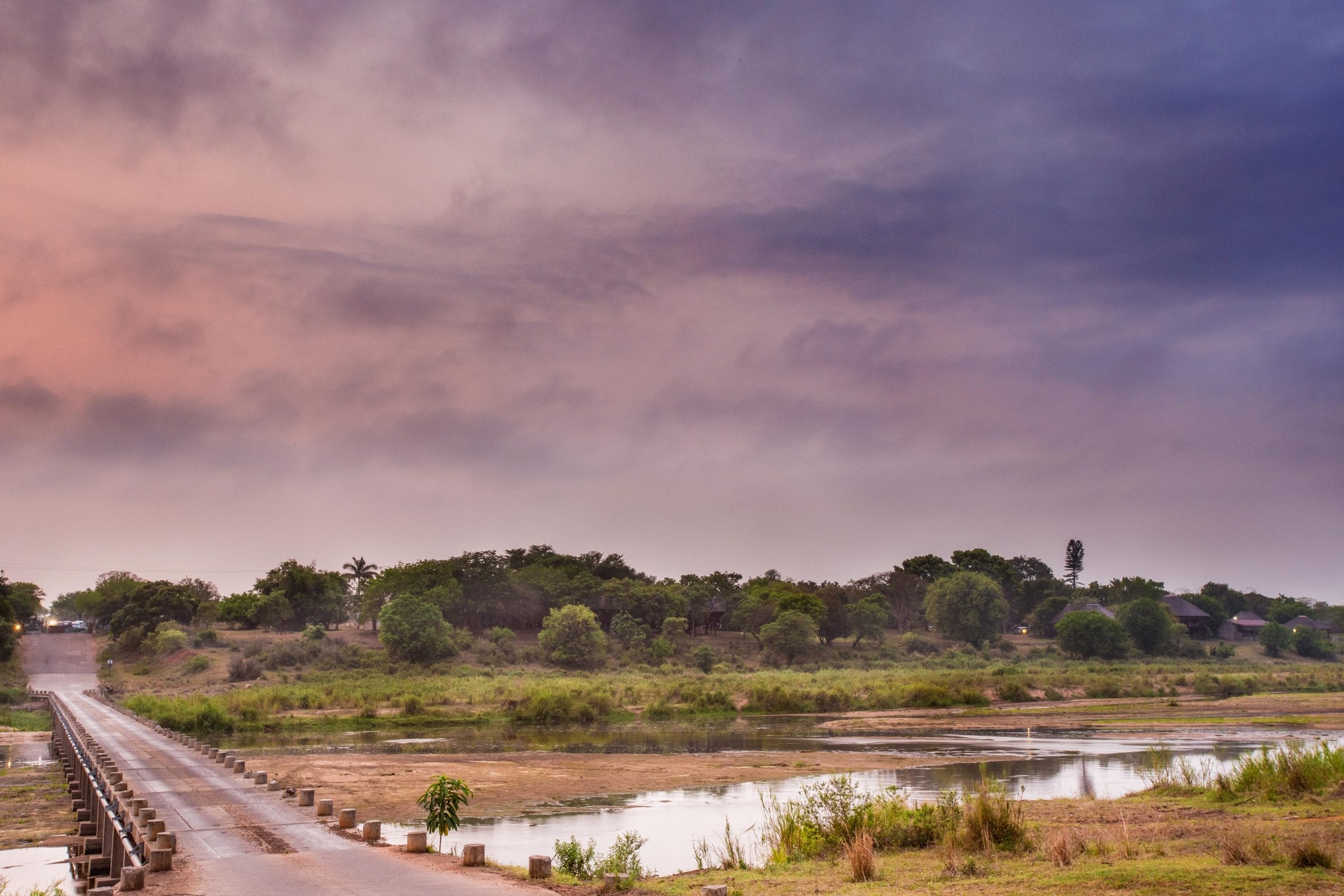 The low-water bridge across the Crocodile River under a pink and purple dusk